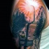 Picture style colored shoulder tattoo of man with sun and mountain