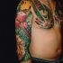 Picture style colored sleeve and chest tattoo of dragon with dice