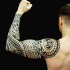 Polynesian style black ink sleeve tattoo of typical large ornaments