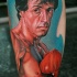 Portrait style colored leg tattoo of Rocky movie hero
