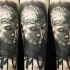 Portrait style detailed arm tattoo of barbarian face