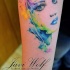 Pretty young girl's portrait with bright make up watercolor tattoo on arm by Javi Wolf