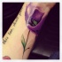 Purple poppy flower tattoo on wrist