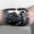 Real lifelike black ink realism style biceps tattoo of swan in lake