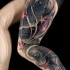 Real photo like colored thigh tattoo of big carp fishes