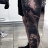Realism style black and white leg tattoo of wolf in dark forest and Indian