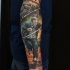 Realism style colored arm tattoo of running man with burning city