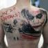Realism style colored back tattoo of Joker with lettering