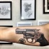 Realism style colored biceps tattoo of very detailed revolver