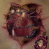 Realism style colored chest tattoo of broken bones with heart
