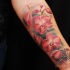 Realism style colored forearm tattoo of beautiful flowers