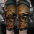 Realism style colored forearm tattoo of bloody human skull with vine