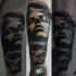 Realism style colored forearm tattoo of human face with skull