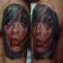 Realism style colored shoulder tattoo of bloody demonic woman face