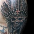 Realism style colored shoulder tattoo of demonic skull with Indian helmet