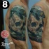 Realism style colored shoulder tattoo of human skull with lizard
