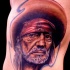 Realism style colored side tattoo of Mexican old man in hat