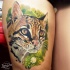Realism style colored thigh tattoo of leopard head
