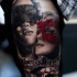 Realism style colored thigh tattoo of woman face with masks