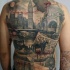 Realism style colored whole back tattoo of medieval London with bloody maniac