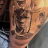 Realism style detailed thigh tattoo of tribal human portrait