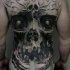 Realism style large whole back tattoo of human like demonic skull