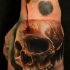 Realism style mystical looking colored hand tattoo of skull