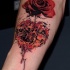 Realism style red colored rose tattoo on forearm with heart