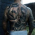 Realism style very detailed back tattoo of woman face with steam and skull