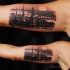 Realism style very detailed biceps tattoo of old city sights