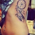 Realism style very detailed side tattoo of dream catcher