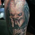 Realistic looking colored thigh tattoo of creepy Predator