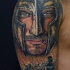 Realistic looking shoulder tattoo of medieval knight face with soldiers