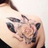 Realistic white rose tattoo on shoulder