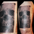 Rectangle shaped black and white human skull dotted work tattoo