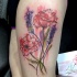 Red poppy and wild flowers colored thigh tattoo in watercolor style