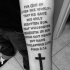 Religious themed black ink forearm tattoo of lettering with cross
