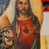 Religious themed colored shoulder tattoo of Jesus