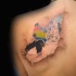 Ripped skin style colored scapular tattoo of amazing snowboarder