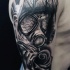 Sharp designed black ink realism style shoulder tattoo of gas mask and rose flower