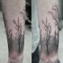Simple black ink arm tattoo of dark forest with trees