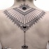 Simple black ink back tattoo of impressive ornament