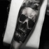 Simple black ink forearm tattoo of human skull
