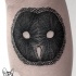 Simple black ink leg tattoo of owl shaped mask