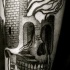 Simple black ink leg tattoo of skull stylized with castle and tree