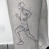 Simple black ink thigh tattoo of running man