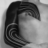 Simple blackwork style sleeve and chest tattoo