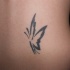 semplice farfalla tatuaggio su parte bassa della schiena per ragazza