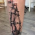 Simple illustrative style leg tattoo of big ship