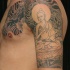 Sitzender Buddha Tattoo am halben Ämel